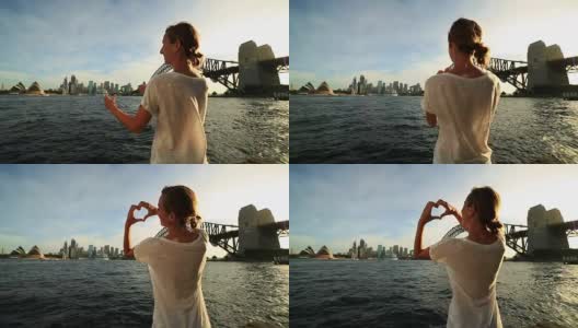悉尼一名女子在空中制作心形指架高清在线视频素材下载