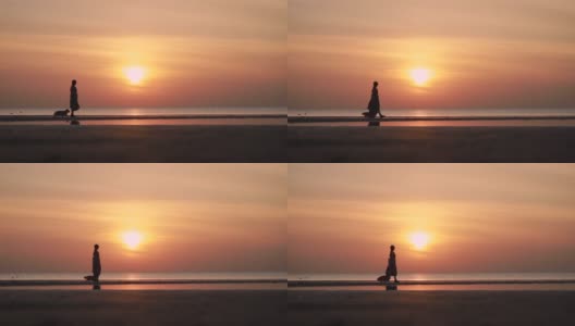 女人和柯基狗走在夕阳下的海滩上度假spbi高清在线视频素材下载