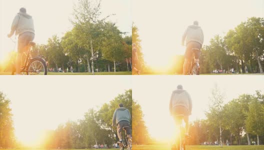 一个在草地上骑自行车的嬉皮士高清在线视频素材下载
