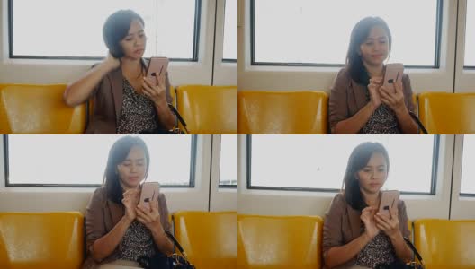 商务女性在城市火车上使用智能手机高清在线视频素材下载