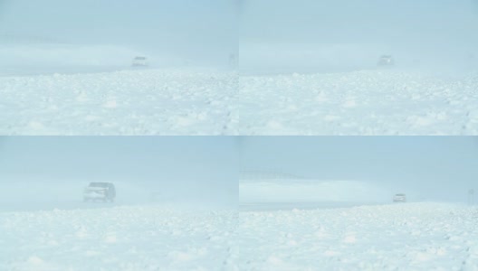 冬季暴风雪与吹雪横跨高速公路和车辆高清在线视频素材下载