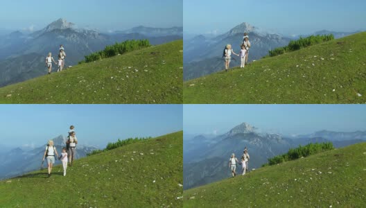 HD CRANE:绿色山丘上的家庭散步高清在线视频素材下载
