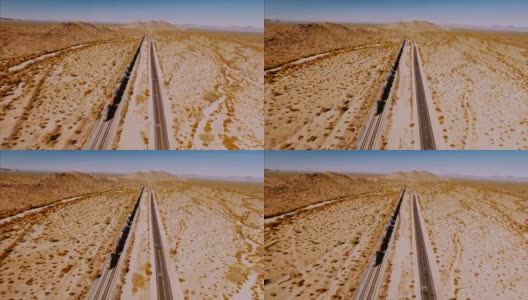 无人机在荒芜的美国沙漠中跟踪一辆大型集装箱机车。高清在线视频素材下载
