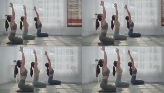 一群通过做瑜伽来学习或锻炼的亚洲妇女。高清在线视频素材下载