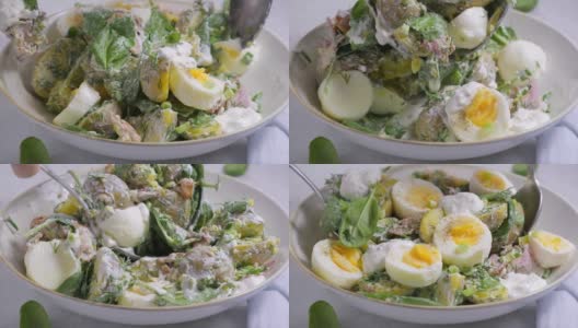 传统的土豆沙拉，培根和鸡蛋放在白色的碗里。高清在线视频素材下载