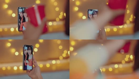 亚洲妇女使用智能手机视频聊天与她的朋友在家里高清在线视频素材下载