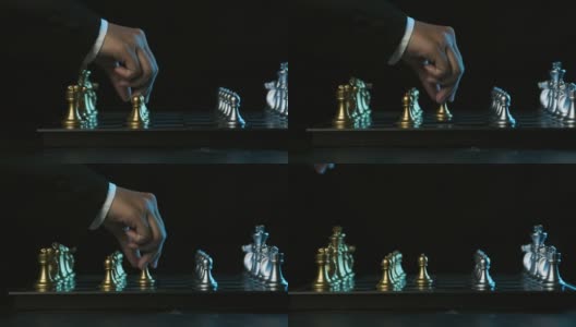 国际象棋的游戏。男手把一枚白色棋子棋子放在棋盘上一个黑色的背景上，经营规划和战略思路高清在线视频素材下载