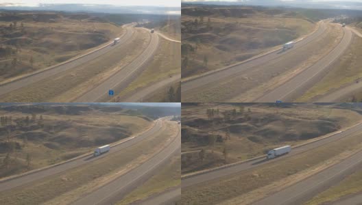天线:货运拖车沿着山路行驶，穿过丘陵景观高清在线视频素材下载