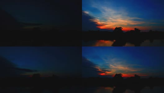 日落在天空，云河反射美丽的剪影森林。时间流逝高清在线视频素材下载