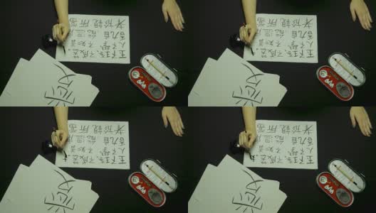 女性用毛笔和墨水在宣纸上书写中国书法。写书法的时候，手握毛笔的时候要靠近。中国书画高清在线视频素材下载