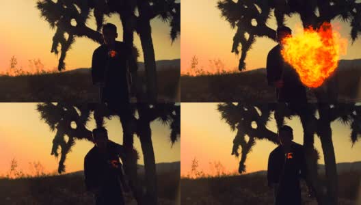 日落时分，沙漠中一个人吹着火前进的剪影高清在线视频素材下载