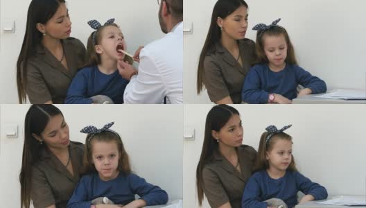 小女孩正在接受男医生的喉部检查高清在线视频素材下载