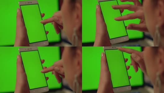 女士用绿色屏幕触摸手机高清在线视频素材下载