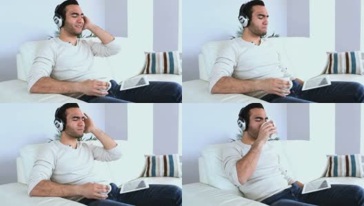 男人在用平板电脑听音乐高清在线视频素材下载