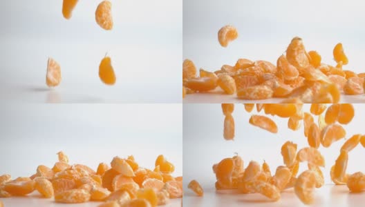 橘子片落在白色背景上的慢镜头高清在线视频素材下载