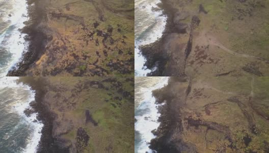 空中镜头。日出时，无人机在复活节岛悬崖上拍摄。令人惊叹的太平洋撞击海岸线和太阳从地平线上升起在一个多云的日子充满色彩的2/3高清在线视频素材下载