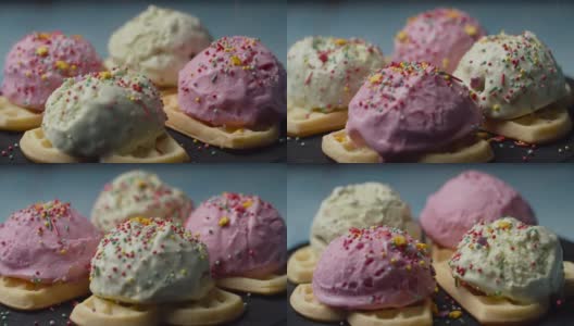自制华夫饼与彩色冰淇淋顶部旋转。在慢镜头中，糕点顶部落在华夫饼上的粉色和绿色的冰淇淋球上。高清在线视频素材下载