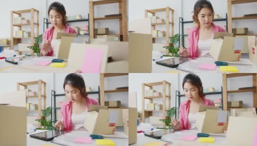 年轻的亚洲企业家女商人检查产品采购订单库存和保存到平板电脑工作在家里的办公室。高清在线视频素材下载