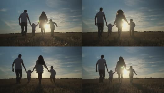 日落时分，父母和孩子们手牵着手在田间奔跑高清在线视频素材下载