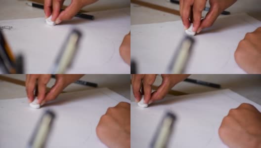 女人的手在她的速写本上画和擦画。高清在线视频素材下载