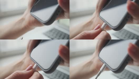 女人的手在手机里插充电线高清在线视频素材下载