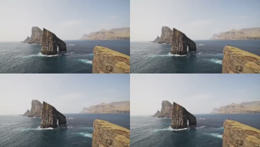德兰加尼尔岩石，悬崖，海浪撞击着法罗岛的岩石脚高清在线视频素材下载