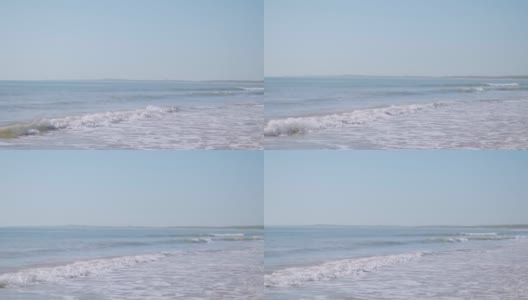 小海浪的慢动作视频打破在Mandvi海滩，库奇，印度的沙滩。热带海滩夏季度假的自然背景。海滩旅游度假高清在线视频素材下载