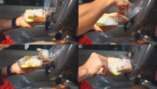 在车里吃盒饭的男人用煎蛋炒罗勒高清在线视频素材下载