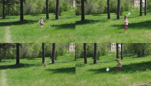 在阳光明媚的夏日里，可爱的小女孩一边走一边用勺子网捉蝴蝶高清在线视频素材下载