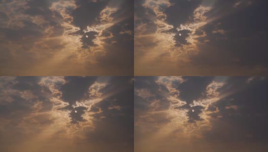 日落时，太阳在云层后面放射出太阳光的特写镜头。阳光穿过云层。自然背景高清在线视频素材下载