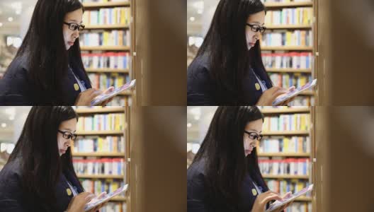 在图书馆里用平板电脑的女人高清在线视频素材下载