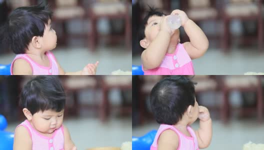 宝宝吃着米饭，喝着瓶子里的水高清在线视频素材下载