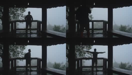 一名徒步旅行者在热带雨林的薄雾中伸展手臂高清在线视频素材下载