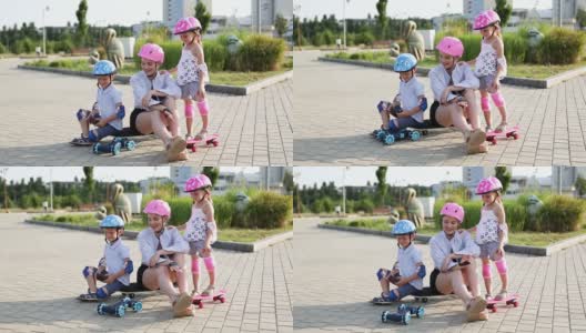 妈妈、儿子和女儿用遥控器在公园里玩汽车。高清在线视频素材下载