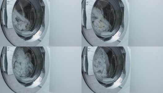 工作纺纱洗衣机，家用洗衣机洗白衣服高清在线视频素材下载