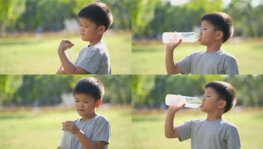 亚洲男孩在户外公园喝水高清在线视频素材下载
