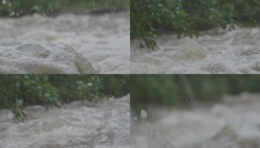 一场倾盆大雨过后，湍急的山河中溅满了泡沫和水花，跳过了岩石高清在线视频素材下载