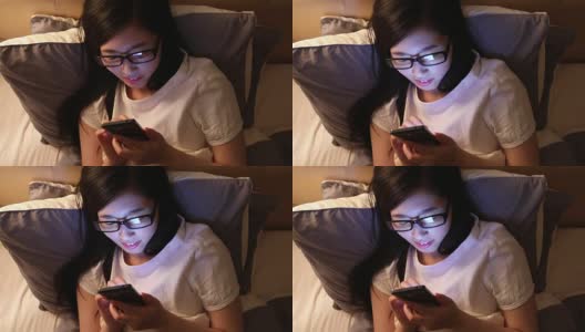 亚洲女性在床上使用智能手机高清在线视频素材下载