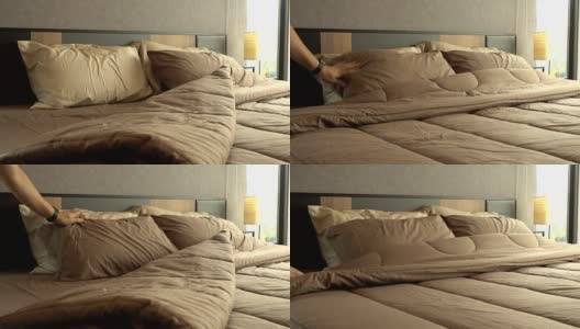 4k的男人手工整理和清洁卧室的床高清在线视频素材下载
