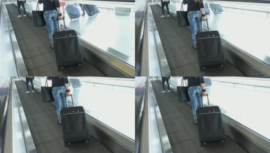 带着行李的女乘客在机场/火车站的移动人行道上旅行高清在线视频素材下载