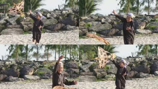 亚洲男孩玩他的传统风筝。他在海滩上跑步。高清在线视频素材下载