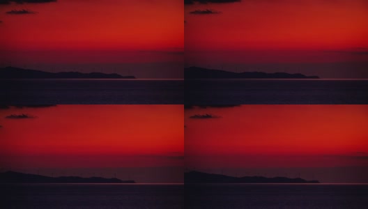 日落时风力涡轮机农场的海景高清在线视频素材下载