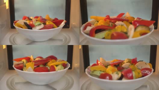 使用微波炉烹饪食物。用微波炉加热蔬菜沙拉高清在线视频素材下载