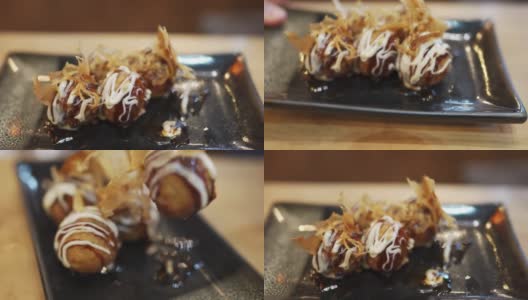 用筷子挑章鱼烧，一种球形的日本小吃高清在线视频素材下载