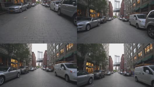 慢镜头:从小飞象那里看布鲁克林大桥，小飞象公寓和路边停着的汽车在夏天清晨的阳光下高清在线视频素材下载