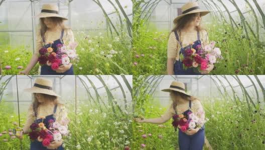 快乐的女人捧着花束沿着盛开的植物走着高清在线视频素材下载