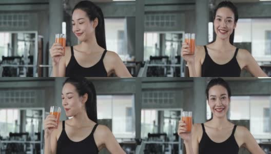 亚洲美女在健身房喝果汁的肖像。高清在线视频素材下载