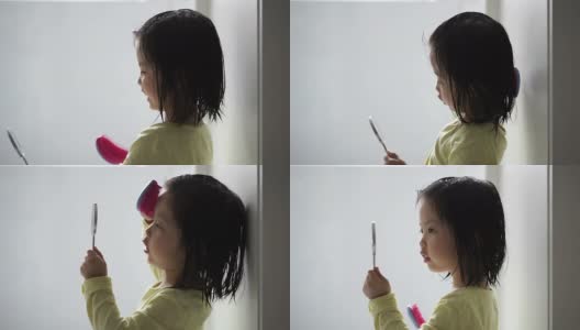 梳头的亚洲女孩高清在线视频素材下载