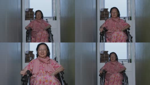 亚洲老年妇女移动自己的电动轮椅高清在线视频素材下载
