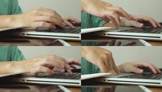 在家工作，用笔记本电脑写博客。咖啡店里男性的手在敲击键盘。高清在线视频素材下载